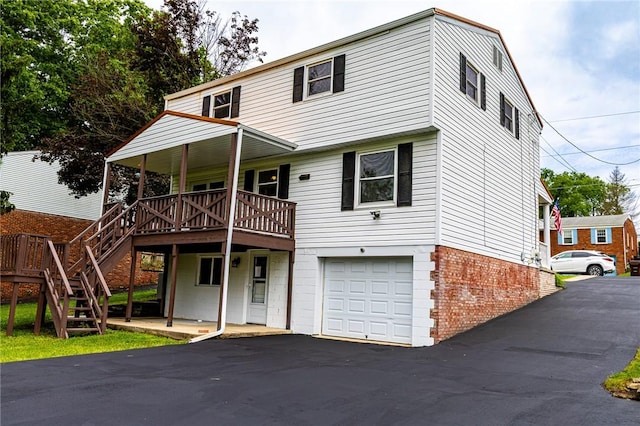 2678 Elaine Dr, Lower Burrell, PA 15068 - view of front of property with an attached garage, driveway, a wooden deck, and stairs
