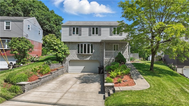 413 Stilley Rd, Jefferson Hills, PA 15025 - colonial-style house with stone siding, a garage, concrete driveway, and a front yard