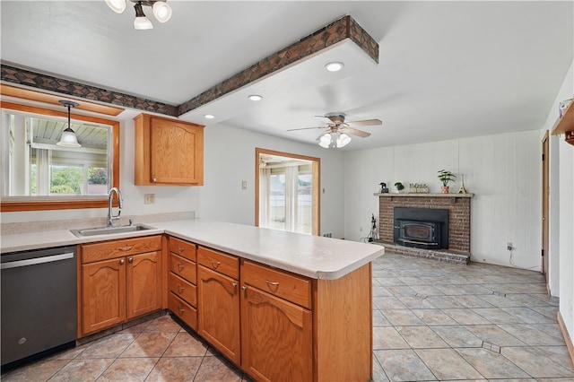 413 Stilley Rd, Jefferson Hills, PA 15025 - kitchen featuring dishwasher, a sink, a peninsula, light countertops, and a wood stove