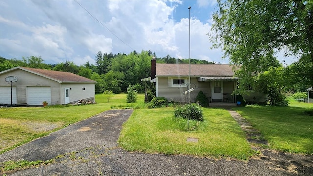 4328 Melwood Rd, Allegheny Twp Wml, PA 15656 - view of front of house with a chimney, a detached garage, a front lawn, and an outdoor structure