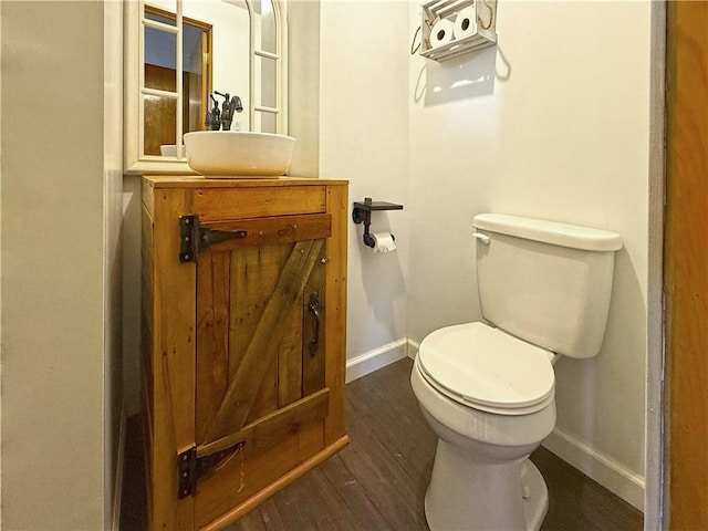 419 Washington Ave, Leechburg Boro, PA 15656 - half bathroom featuring toilet, baseboards, vanity, and wood finished floors