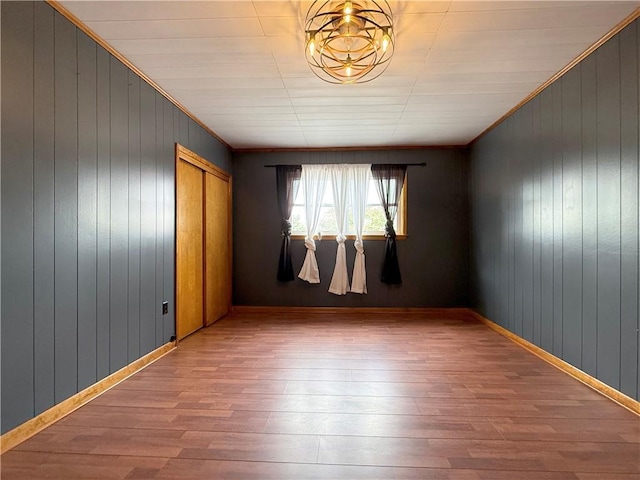 419 Washington Ave, Leechburg Boro, PA 15656 - empty room with wood finished floors, wooden walls, and ornamental molding