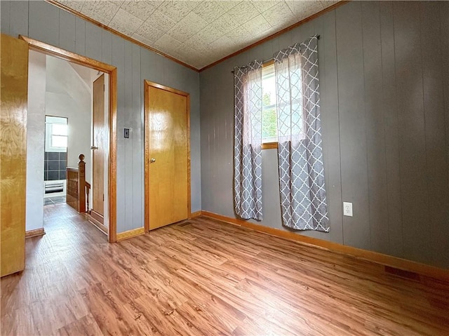 419 Washington Ave, Leechburg Boro, PA 15656 - spare room with ornamental molding, wood finished floors, baseboards, and wood walls