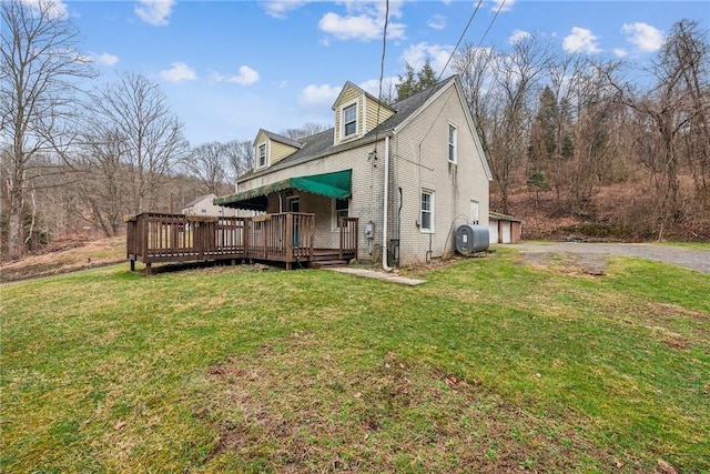 316 Dutchman Run Rd, Lower Burrell, PA 15068 - view of home's exterior with a deck, a yard, heating fuel, a garage, and asphalt driveway
