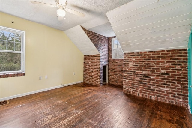 316 Dutchman Run Rd, Lower Burrell, PA 15068 - additional living space featuring hardwood / wood-style flooring, a ceiling fan, brick wall, baseboards, and lofted ceiling