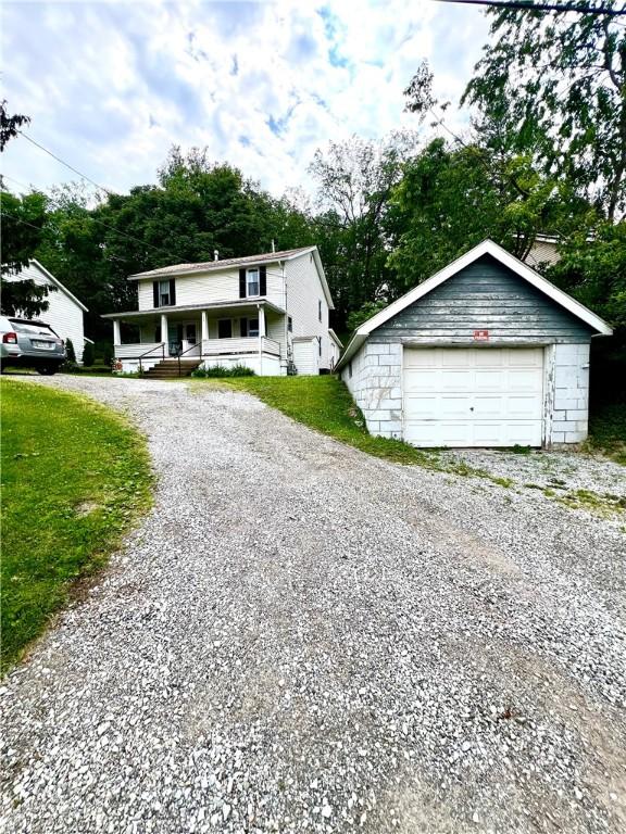 127 Tipple Row Rd, Hempfield Twp Wml, PA 15601 - view of front facade with a detached garage, covered porch, and a front yard
