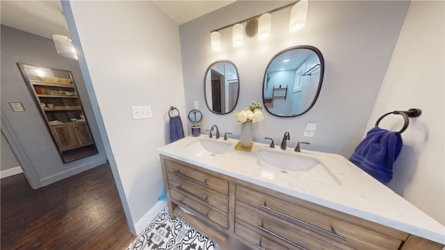 2819 Glenmore, Dormont, PA 15216 - bathroom featuring double vanity, baseboards, and wood finished floors