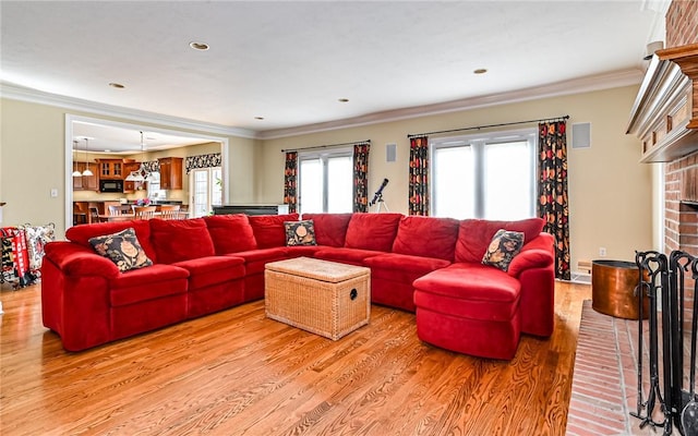 3124 Canterbury Dr, Hampton, PA 15101 - living area with light wood finished floors, a brick fireplace, ornamental molding, and recessed lighting