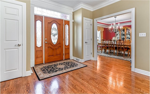 3124 Canterbury Dr, Hampton, PA 15101 - foyer featuring a chandelier, wood finished floors, baseboards, plenty of natural light, and ornamental molding