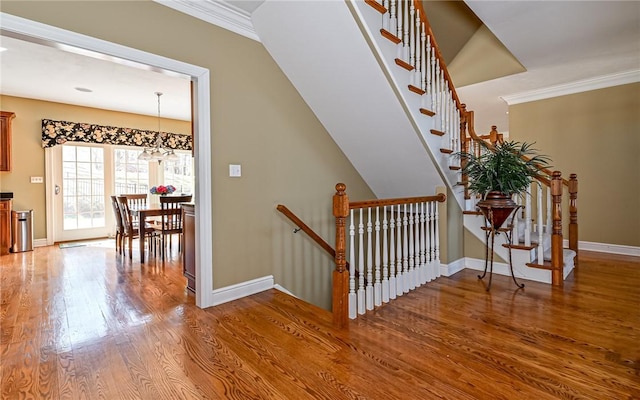 3124 Canterbury Dr, Hampton, PA 15101 - stairs featuring wood finished floors, baseboards, crown molding, and a chandelier