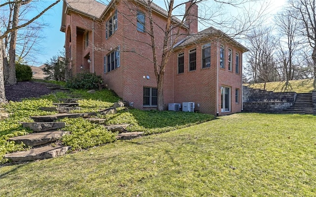 3124 Canterbury Dr, Hampton, PA 15101 - view of property exterior with brick siding, a lawn, a chimney, and central AC
