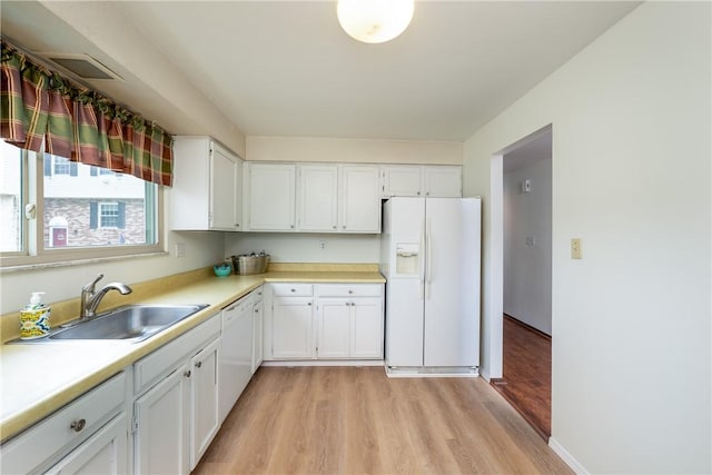 3131 Cheltenham Ct, Hampton, PA 15044 - kitchen featuring white appliances, a sink, light wood-style floors, and white cabinetry