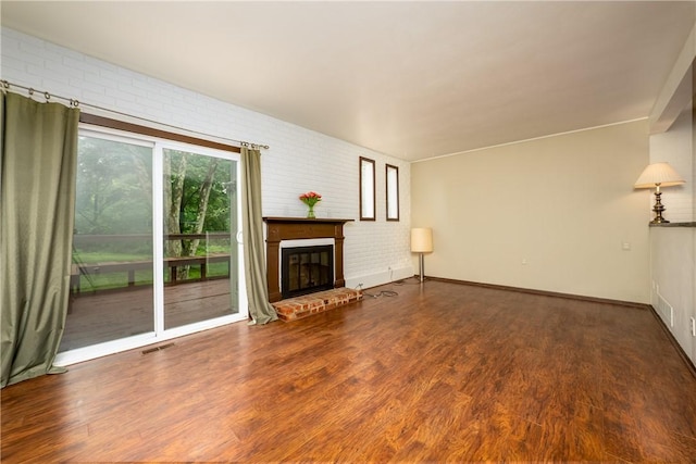 3131 Cheltenham Ct, Hampton, PA 15044 - unfurnished living room featuring brick wall, wood finished floors, and a fireplace