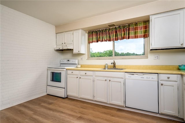 3131 Cheltenham Ct, Hampton, PA 15044 - kitchen featuring white appliances, brick wall, a sink, under cabinet range hood, and light countertops