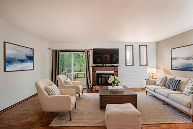 3131 Cheltenham Ct, Hampton, PA 15044 - living room featuring wood finished floors, brick wall, a fireplace with raised hearth, and baseboards
