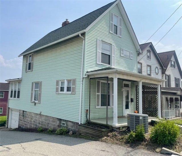 622 E 10th Ave, Tarentum, PA 15084 - view of home's exterior featuring a porch, central AC unit, a chimney, and roof with shingles