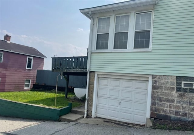 622 E 10th Ave, Tarentum, PA 15084 - view of home's exterior with a garage, a deck, and a lawn