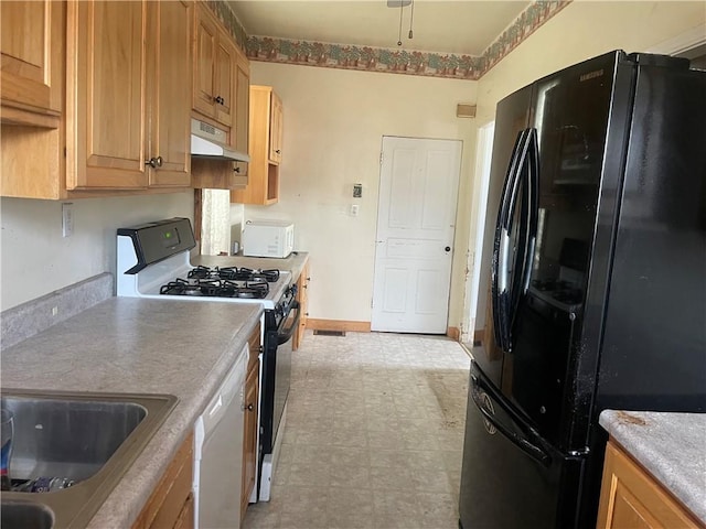 622 E 10th Ave, Tarentum, PA 15084 - kitchen featuring white appliances, light flooring, under cabinet range hood, a sink, and baseboards