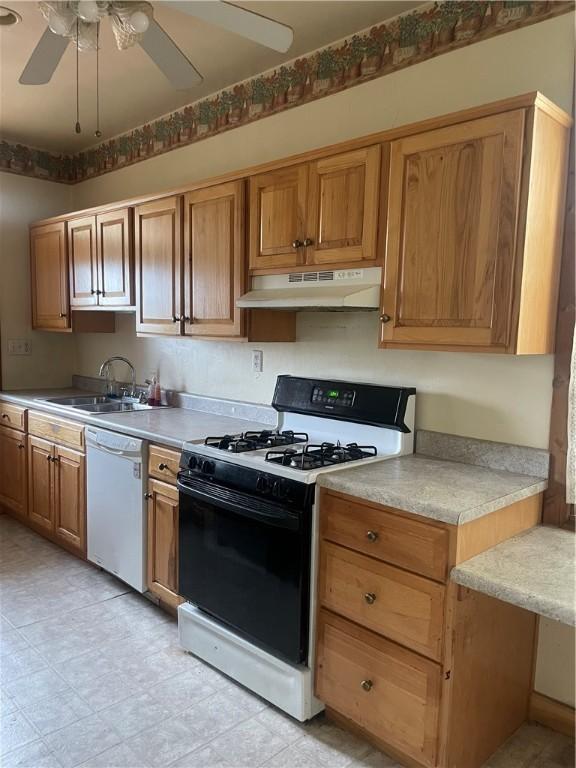 622 E 10th Ave, Tarentum, PA 15084 - kitchen with white appliances, under cabinet range hood, a sink, ceiling fan, and light countertops