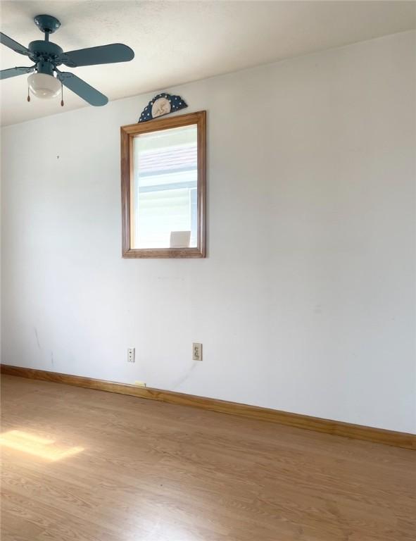622 E 10th Ave, Tarentum, PA 15084 - spare room featuring wood finished floors, baseboards, and a ceiling fan