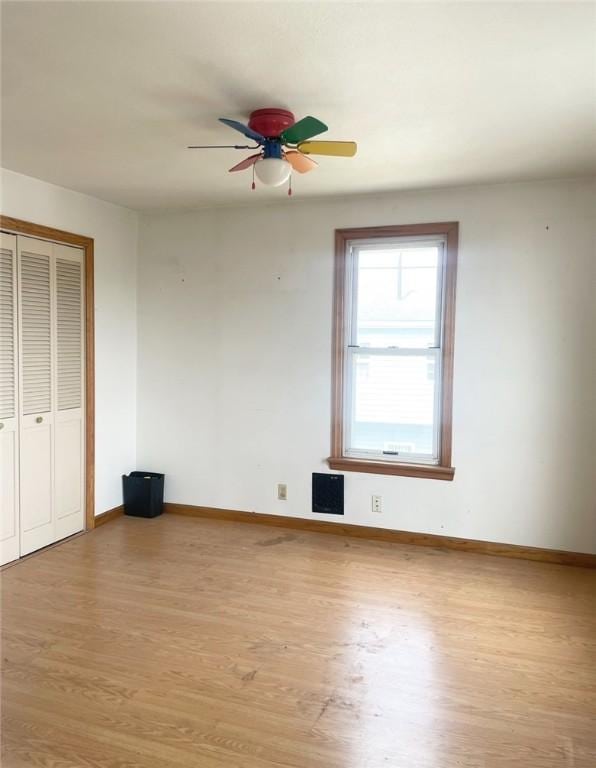 622 E 10th Ave, Tarentum, PA 15084 - unfurnished bedroom with light wood finished floors, baseboards, a closet, and a ceiling fan