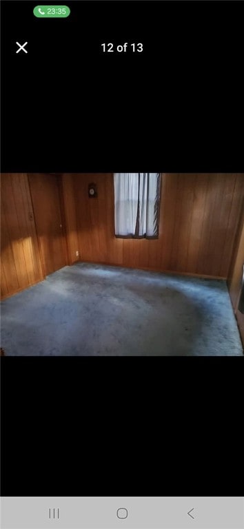 146 Back St, Quemahoning Twp, PA 15936 - carpeted empty room featuring wood walls