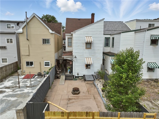 216 11th St, Sharpsburg, PA 15215 - back of property with a patio, a fenced backyard, and an outdoor fire pit