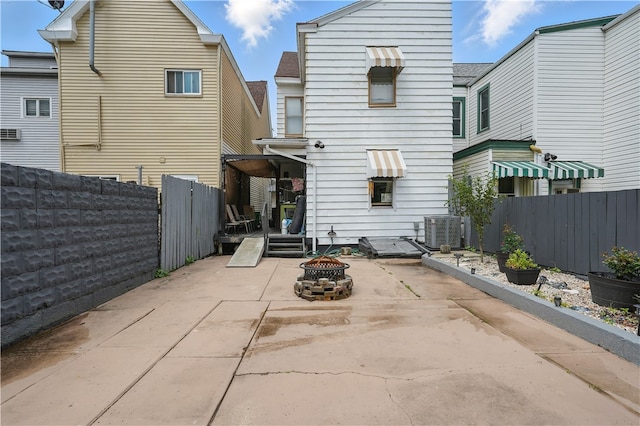 216 11th St, Sharpsburg, PA 15215 - back of property with a patio, a fenced backyard, central air condition unit, and an outdoor fire pit