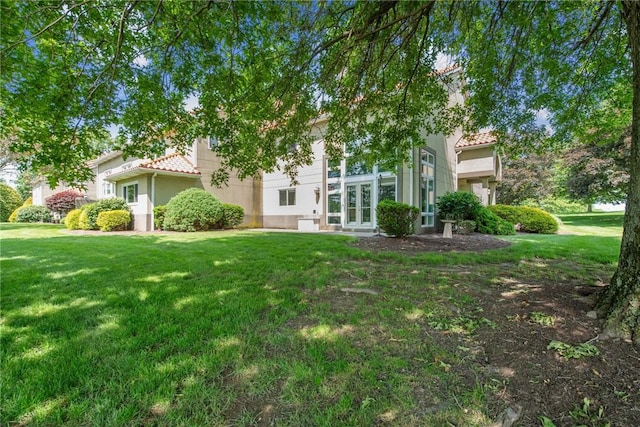 3532 Fairway Ct, Blairsville Area, PA 15717 - obstructed view of property with a tile roof, a front lawn, and stucco siding