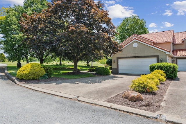 3532 Fairway Ct, Blairsville Area, PA 15717 - view of front facade with a tiled roof, a garage, stucco siding, and driveway