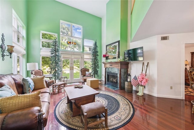 3532 Fairway Ct, Blairsville Area, PA 15717 - living area featuring a towering ceiling, wood finished floors, french doors, a fireplace, and baseboards