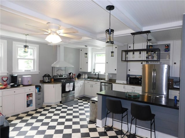 508 Bosses Row, Crucible, PA 15325 - kitchen with appliances with stainless steel finishes, wall chimney exhaust hood, plenty of natural light, light floors, and beamed ceiling