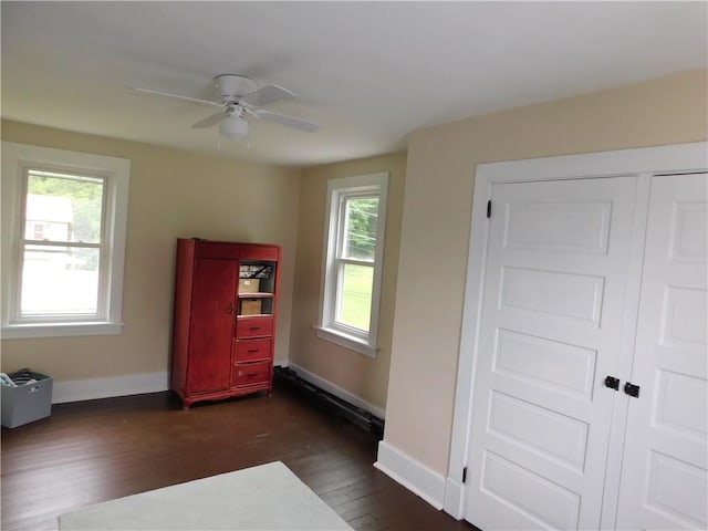 508 Bosses Row, Crucible, PA 15325 - unfurnished bedroom featuring dark wood-style floors, baseboards, a ceiling fan, and a baseboard radiator
