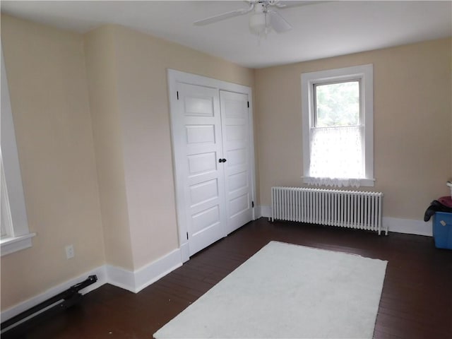 508 Bosses Row, Crucible, PA 15325 - unfurnished bedroom featuring radiator, dark wood-style flooring, baseboards, and a ceiling fan
