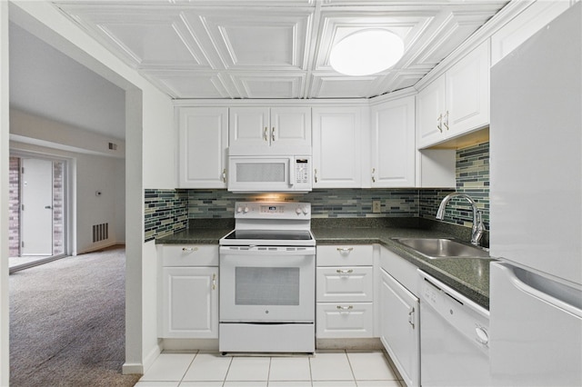 595 Calais Dr Unit 324, Mccandless, PA 15237 - kitchen with white appliances, a sink, dark countertops, white cabinetry, and backsplash