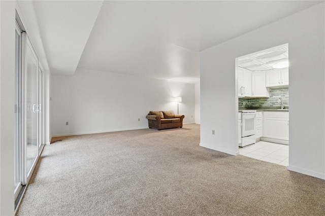 595 Calais Dr Unit 324, Mccandless, PA 15237 - unfurnished living room featuring light colored carpet, a sink, and baseboards