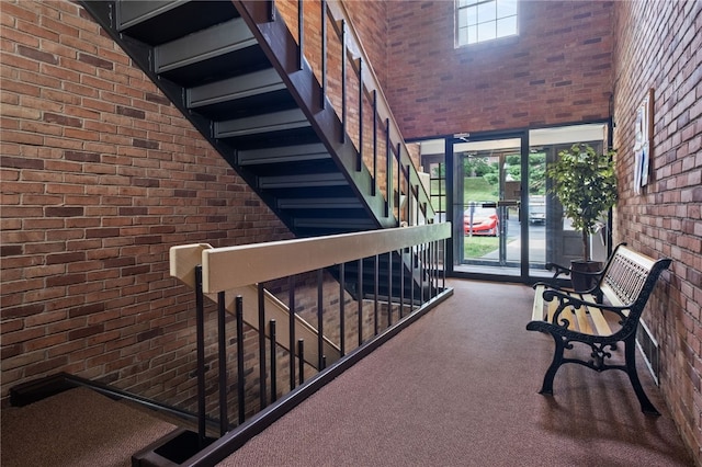 595 Calais Dr Unit 324, Mccandless, PA 15237 - staircase featuring brick wall, carpet floors, and a towering ceiling