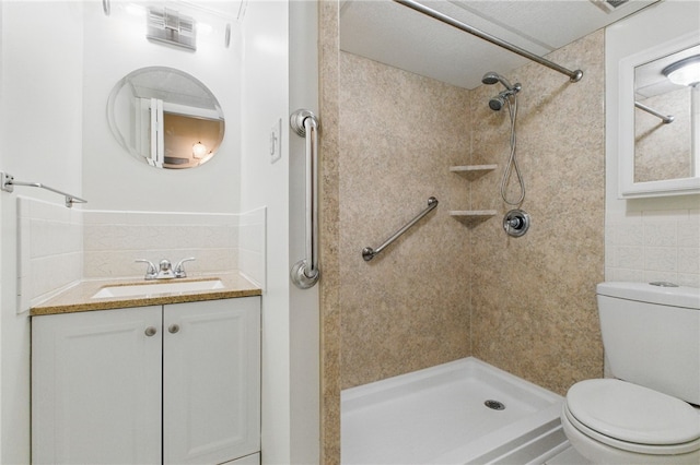 595 Calais Dr Unit 324, Mccandless, PA 15237 - full bath featuring toilet, tiled shower, vanity, and tile walls