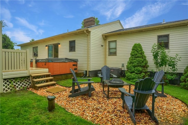 2971 Acre Rd, Scott Twp Law, PA 16101 - rear view of house featuring a hot tub, a fire pit, a chimney, central AC unit, and a yard