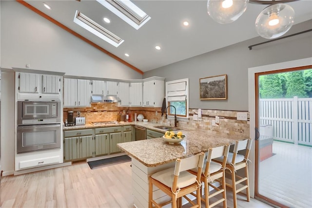 2971 Acre Rd, Scott Twp Law, PA 16101 - kitchen featuring a sink, a peninsula, a skylight, vaulted ceiling, and healthy amount of natural light