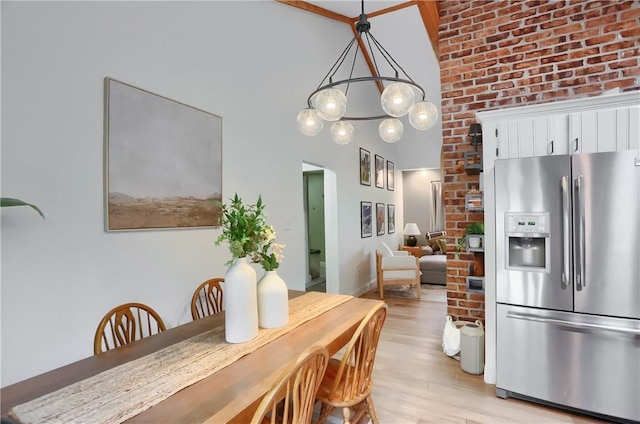 2971 Acre Rd, Scott Twp Law, PA 16101 - dining space featuring a high ceiling, light wood-style floors, a chandelier, and brick wall