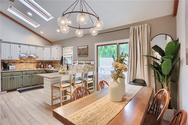 2971 Acre Rd, Scott Twp Law, PA 16101 - dining room featuring lofted ceiling, a chandelier, a skylight, light wood-style floors, and recessed lighting