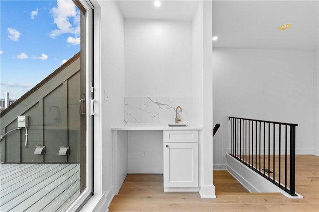 240 44th St, Lawrenceville, PA 15201 - bathroom with a sink, wood finished floors, recessed lighting, and backsplash