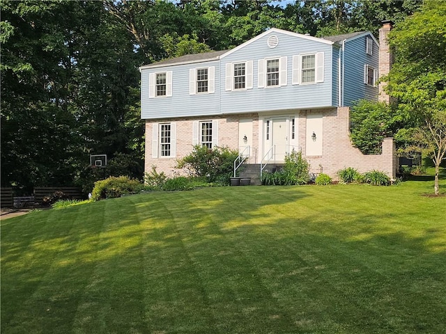 728 Heathergate, Indiana Twp Nal, PA 15238 - colonial home with brick siding, a front yard, view of wooded area, and a chimney
