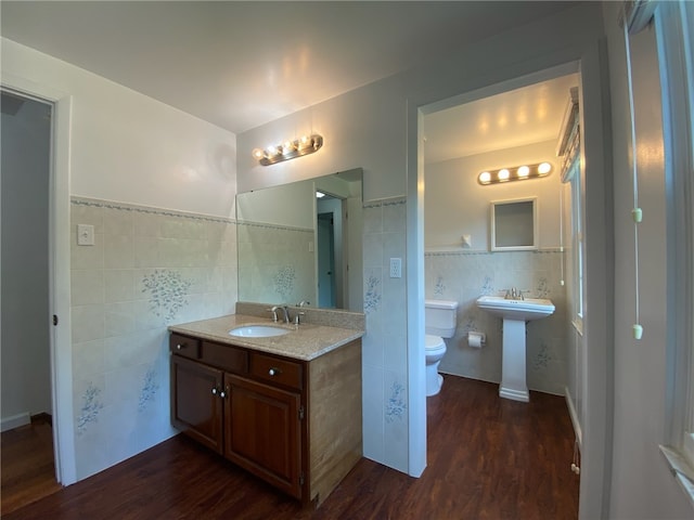 728 Heathergate, Indiana Twp Nal, PA 15238 - bathroom with tile walls, a sink, toilet, wood finished floors, and wainscoting