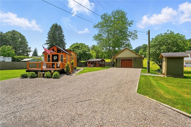 319 Ferry Ln, North-Other Area, PA 16370 - view of front of home with a deck, gravel driveway, an outdoor structure, and a detached garage