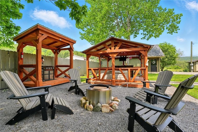 319 Ferry Ln, North-Other Area, PA 16370 - view of play area with an outdoor fire pit, a gazebo, a fenced backyard, and a deck