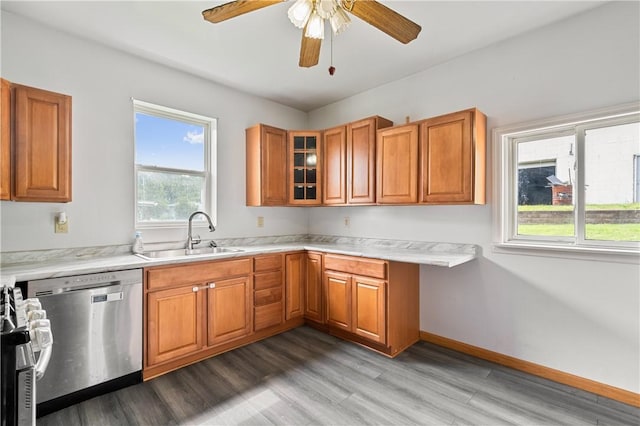 147 Church St, Claysville, PA 15323 - kitchen featuring a sink, stainless steel appliances, brown cabinetry, a ceiling fan, and light wood-style floors