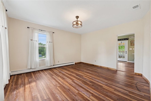 203 E Main St, New Alexandria, PA 15670 - empty room featuring a baseboard heating unit, hardwood / wood-style flooring, a chandelier, and baseboards