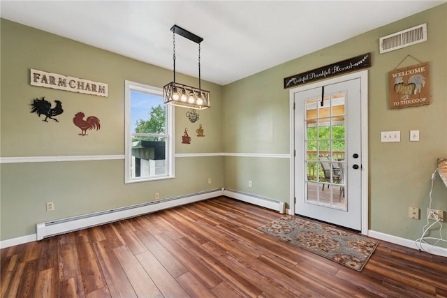 203 E Main St, New Alexandria, PA 15670 - unfurnished dining area featuring wood finished floors, baseboards, and baseboard heating